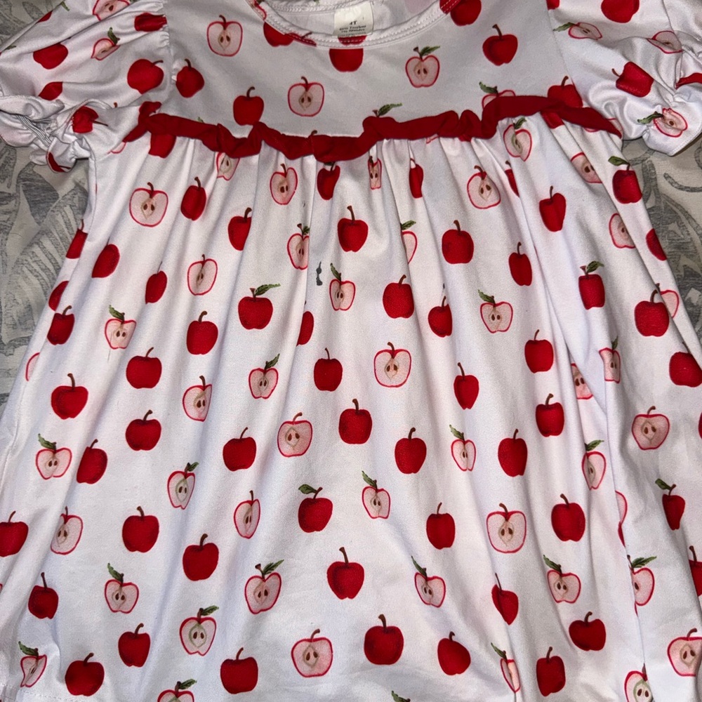 White Baby Dress with Red Apple Print has matching red ruffle shorts